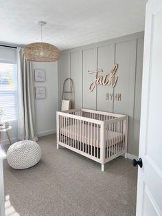 a baby's room with a white crib and gray carpet