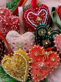 a bunch of heart shaped ornaments hanging from a christmas tree