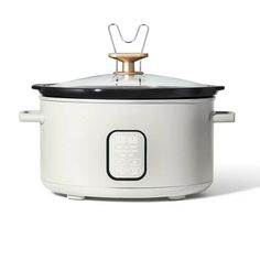 an electric crock pot with the lid open on a white background, it has a black handle