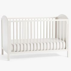 a white crib with no sheets on it, in front of a white background