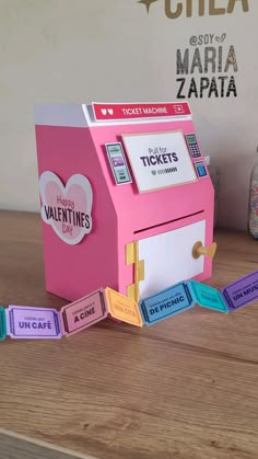 a valentine's day candy machine is sitting on a table