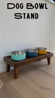 the dog bowl stand has three bowls on it