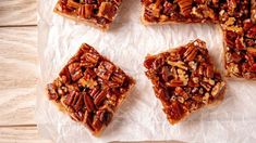 four pieces of pecan pie on wax paper