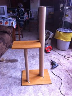 a wooden table with two poles on it in the middle of a living room area