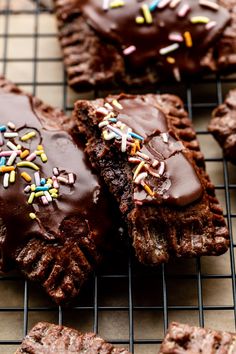 cookies with chocolate frosting and sprinkles on a cooling rack