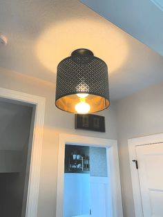 a light that is hanging from the ceiling in a room with a door and window