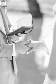 the bride and groom hold hands during their wedding ceremony