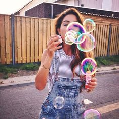 a woman blowing bubbles in front of her face