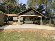 a house with a covered patio in the yard