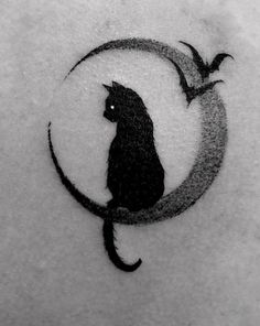 a black cat sitting on top of a crescent