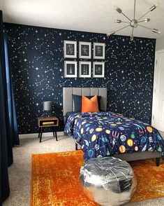 a bedroom decorated in blue and orange with pictures on the wall