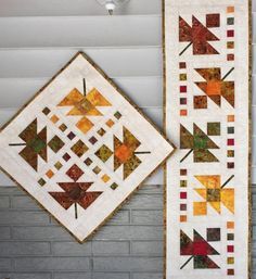 two quilts hanging on the wall next to each other