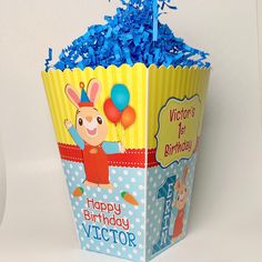 a birthday cup filled with blue candy