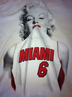 an image of a woman covering her mouth with a white shirt that says, miami 6