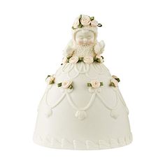 a white porcelain figurine with flowers on it