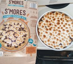 a box of s'mores sitting on top of a stove next to a pie