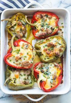 stuffed peppers in a casserole dish with cheese