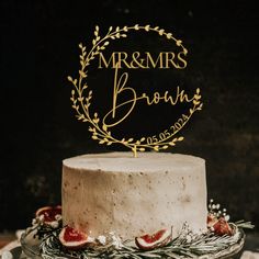 a white cake topped with a gold mr and mrs sign