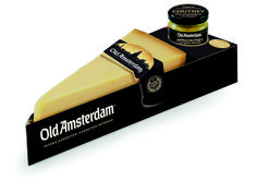 an old amsterdam cheese is in a black box with a tag on the front and bottom