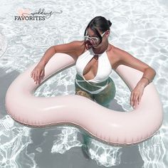 a woman floating on an inflatable ring in the water while wearing goggles