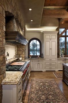 an image of a kitchen setting with stone walls and wood flooring in the middle