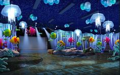 an underwater themed party with fish and jellyfish in the water, under lights and decorations