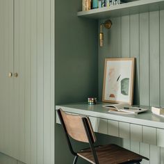 a chair sitting on top of a desk next to a book shelf