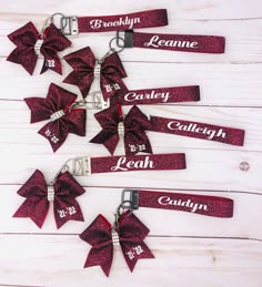 red glitter cheer bows with name tags on them for personalized keychains or lanyards