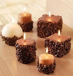 six candles are sitting on a table with coffee beans