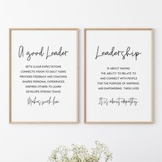 two framed posters with the words good leader and leadership on them next to a vase filled with baby's breath flowers