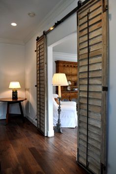 an open sliding door with the words folding and sliding doors on it in front of a bedroom