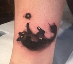 a black and white cat tattoo on the leg