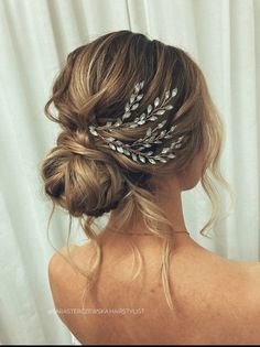 a woman wearing a hair comb with feathers in it