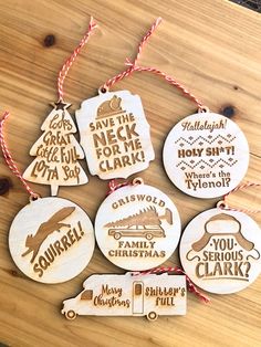 six christmas ornaments hanging on a wooden table