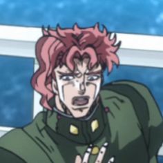 an anime character with red hair and green outfit standing in front of the ocean holding his hand up