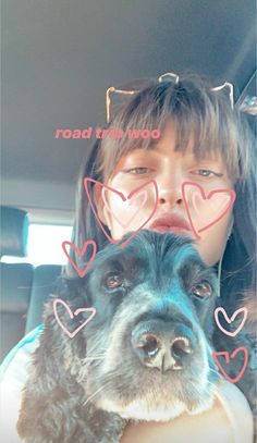 a girl and her dog in the back seat of a car with hearts drawn on them