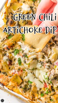 green chili artichoke dip in a casserole dish with tortilla chips