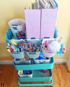 a cart filled with lots of crafting supplies on top of a hard wood floor