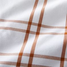 an orange and white checkered fabric is seen in close up view on the surface