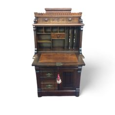 an old fashioned desk with drawers on it