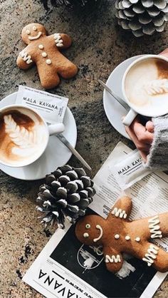 two cups of coffee and some cookies on a table