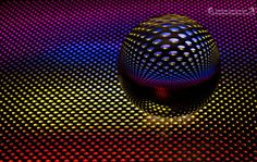 an abstract image of a sphere with dots on it and the colors are multicolored