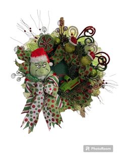 a christmas wreath with an elf's hat on it