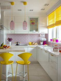 a kitchen with yellow chairs and pink tile backsplashing, white countertops