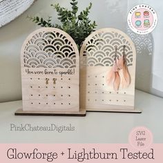 two wooden pegs with earrings hanging from them and the words glowforge lightburn tested