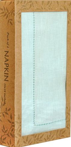 an open box with a white napkin in it's bottom and green trim on the front