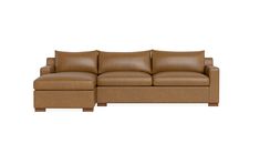 a brown leather couch sitting on top of a white floor