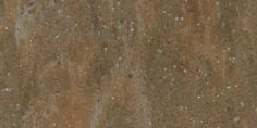 a close up view of the surface of a concrete slab with brown and white speckles