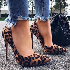 a woman's legs wearing leopard print high heels