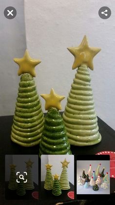 three small ceramic christmas trees sitting on top of a table